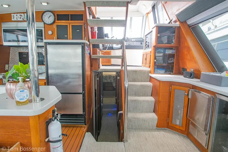 Slide: The Image of Interior of 1986 Bayliner 4588 Pilothouse with stairs, kitchen, and appliances. - 19
