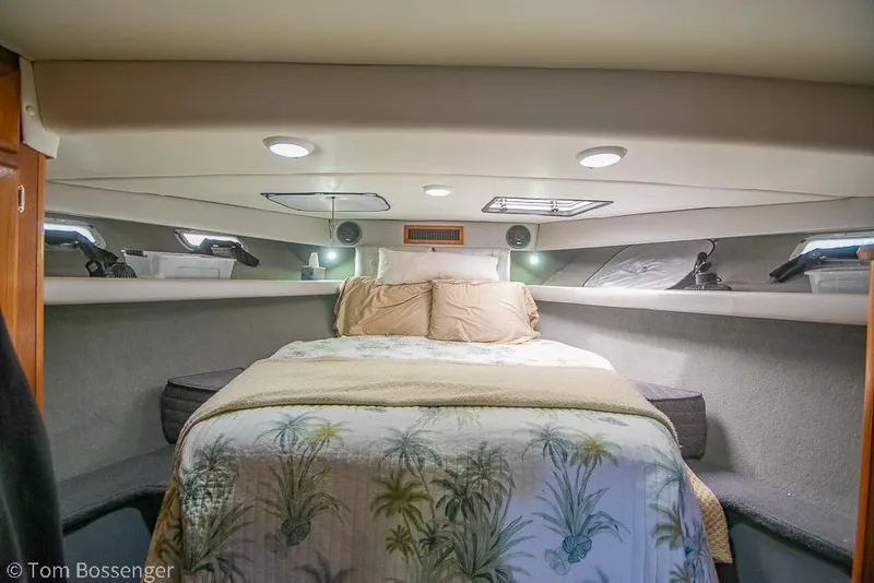 Slide: The Image of 1986 Bayliner 4588 Pilothouse cabin with cozy bed and tropical-themed bedding. - 21