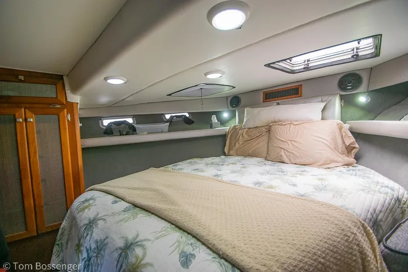 Slide: The Image of Cozy bedroom interior of 1986 Bayliner 4588 Pilothouse yacht with bed and wooden cabinets. - 22