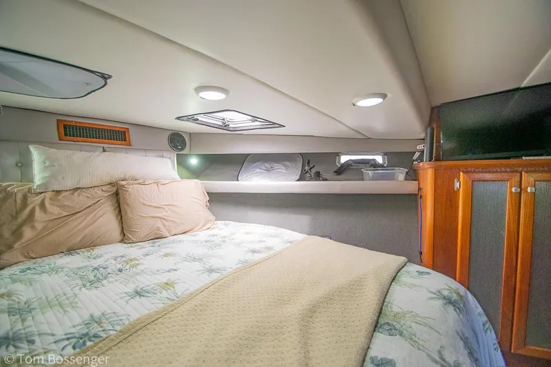 Slide: The Image of Cozy cabin interior of 1986 Bayliner 4588 Pilothouse with bed and wooden cabinetry. - 23