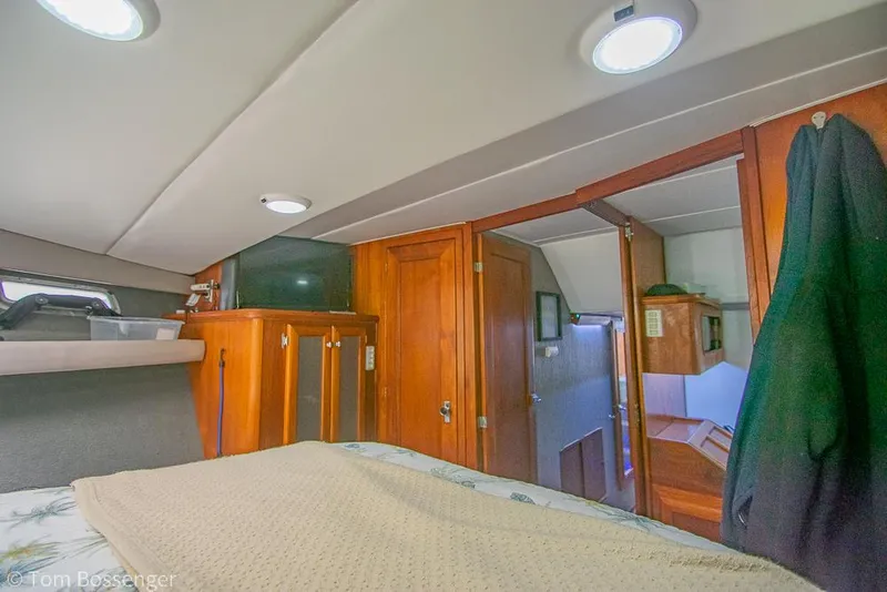 Slide: The Image of Interior cabin of 1986 Bayliner 4588 Pilothouse with wood paneling and cozy furnishings. - 24