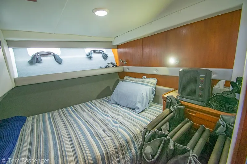 Slide: The Image of Cozy cabin interior of 1986 Bayliner 4588 Pilothouse with striped bedding and wooden accents. - 28