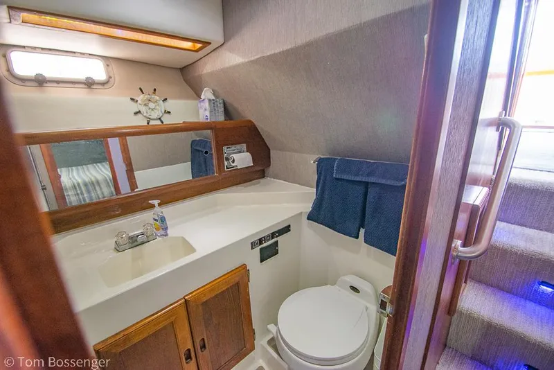 Slide: The Image of 1986 Bayliner 4588 Pilothouse bathroom with sink, mirror, and toilet. - 29