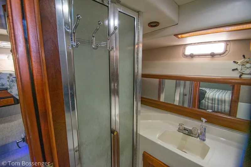 Slide: The Image of 1986 Bayliner 4588 Pilothouse bathroom with shower, sink, and mirror. - 30