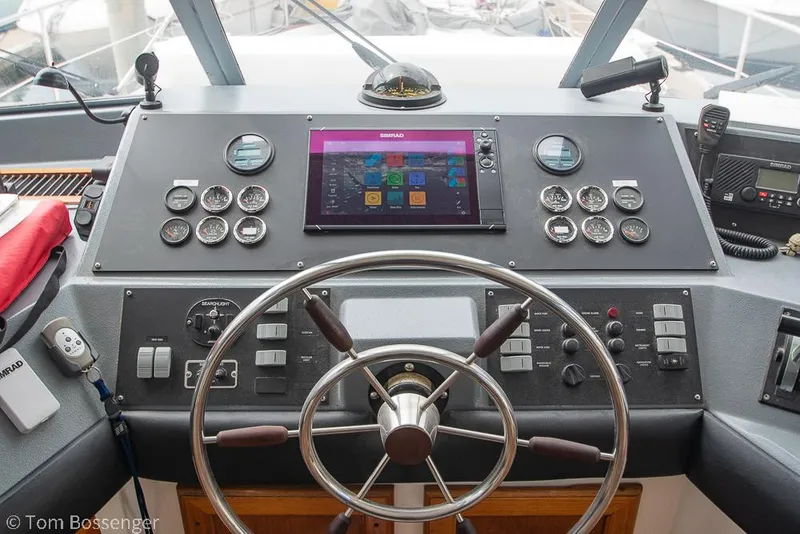 Slide: The Image of 1986 Bayliner 4588 Pilothouse helm with steering wheel, gauges, and navigation display. - 34