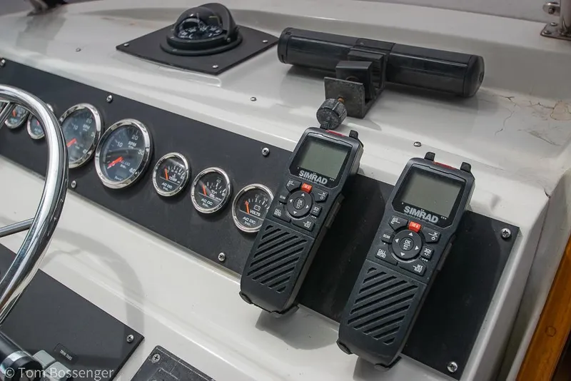 Slide: The Image of Control panel of 1986 Bayliner 4588 Pilothouse with gauges and Simrad radios. - 46