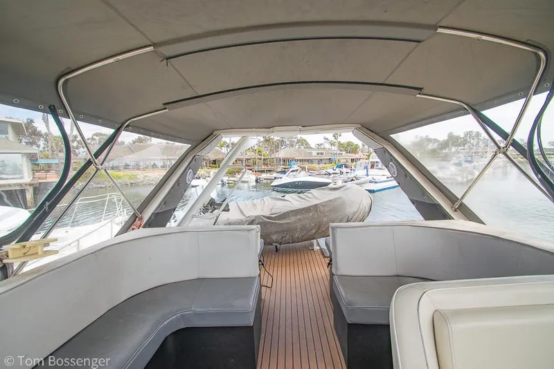 Slide: The Image of 1986 Bayliner 4588 Pilothouse interior with seating, docked at marina. - 47
