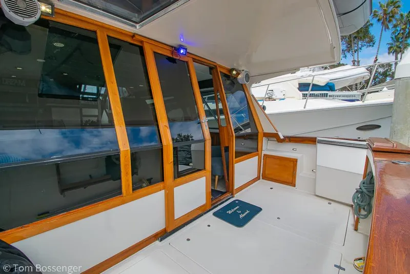 Slide: The Image of 1986 Bayliner 4588 Pilothouse yacht with wooden trim and spacious deck area. - 7