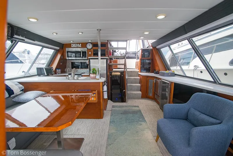 Slide: The Image of Interior of 1986 Bayliner 4588 Pilothouse yacht with modern amenities and spacious seating. - 9