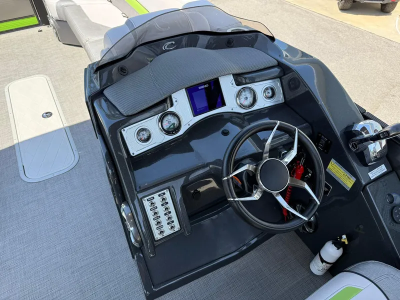Slide: The Image of 2017 Crest Caliber 230 SLR2 boat dashboard with steering wheel and control panel. - 12