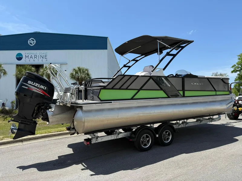 Slide: The Image of 2017 Crest Caliber 230 SLR2 pontoon boat with Suzuki outboard motor on trailer. - 2