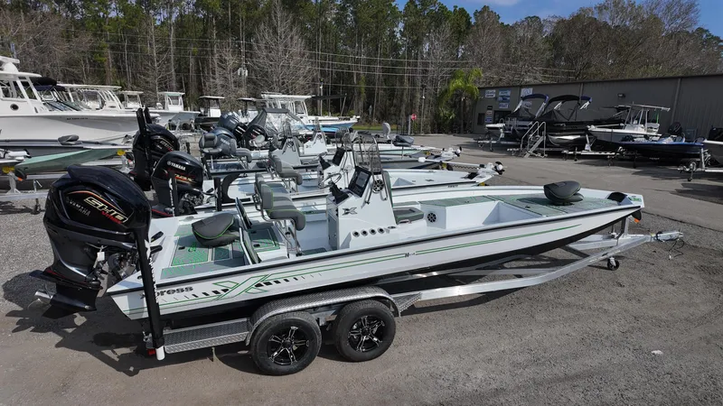 Slide: The Image of 2025 Xpress H24B boat on trailer in outdoor showroom. - 14