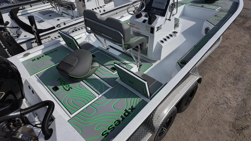 Slide: The Image of 2025 Xpress H24B boat interior with green accents and modern seating. - 19