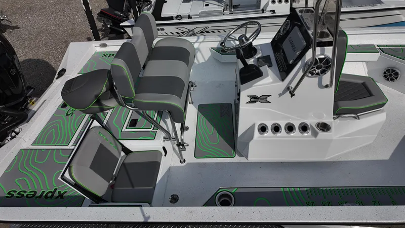 Slide: The Image of 2025 Xpress H24B boat interior with seating, steering console, and modern design elements. - 22