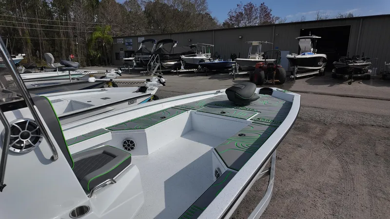 Slide: The Image of 2025 Xpress H24B boat in a marina with other boats in the background. - 23