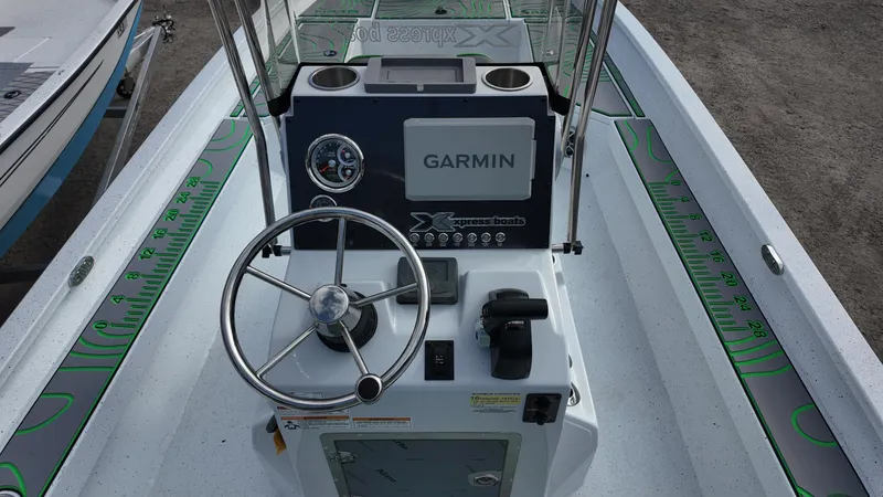 Slide: The Image of Center console of 2025 Xpress H24B boat with Garmin navigation system. - 32