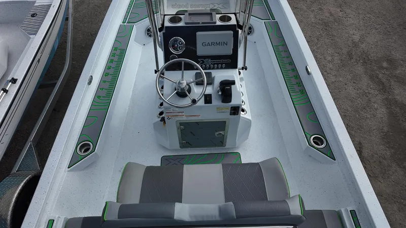 Slide: The Image of 2025 Xpress H24B boat interior with Garmin system and seating. - 33