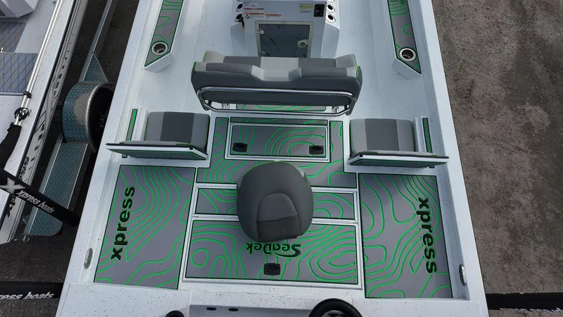 Slide: The Image of 2025 Xpress H24B boat interior with seating and storage compartments, featuring green and gray design. - 34