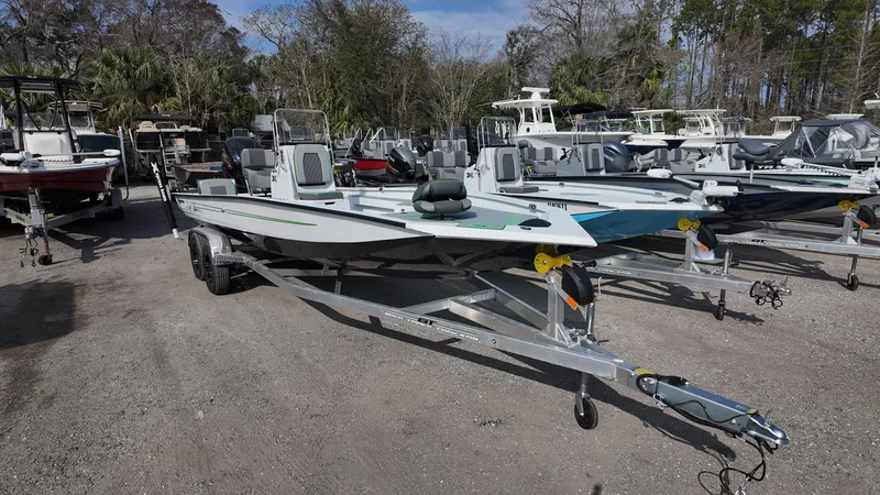Slide: The Image of 2025 Xpress H24B boat on trailer in outdoor showroom. - 4
