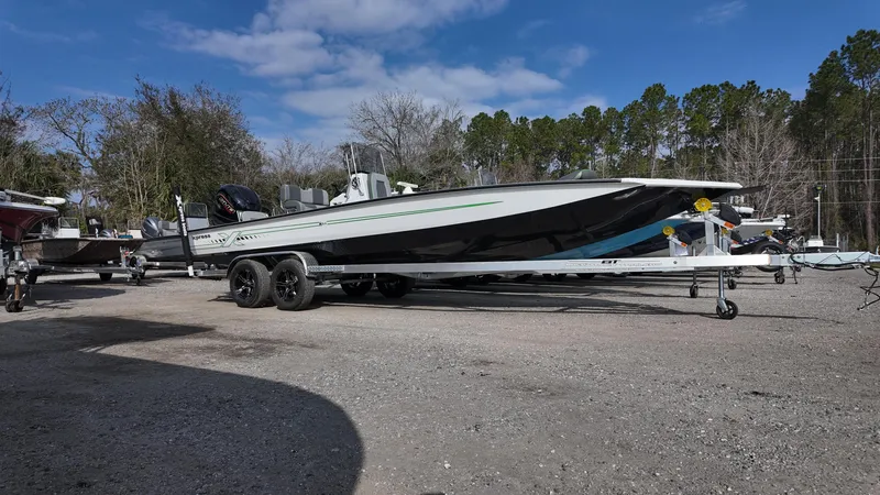 Slide: The Image of 2025 Xpress H24B boat on trailer in outdoor setting, surrounded by trees and clear sky. - 8