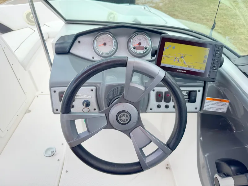 Slide: The Image of Steering wheel and dashboard of 2015 Yamaha Boats SX190 with navigation display. - 15