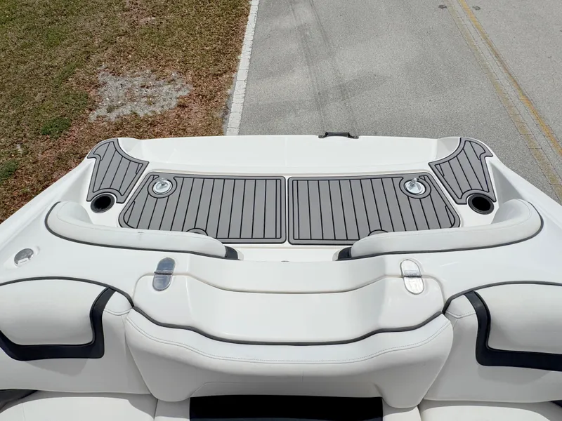 Slide: The Image of 2015 Yamaha SX190 boat deck with sleek seating and storage compartments. - 27
