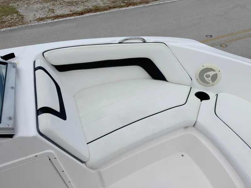 Slide: The Image of 2015 Yamaha Boats SX190 interior seating with white upholstery and speaker. - 9