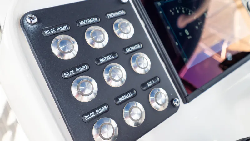 Slide: The Image of Control panel of 2022 Intrepid 345 Valor boat with labeled buttons and display screen. - 15
