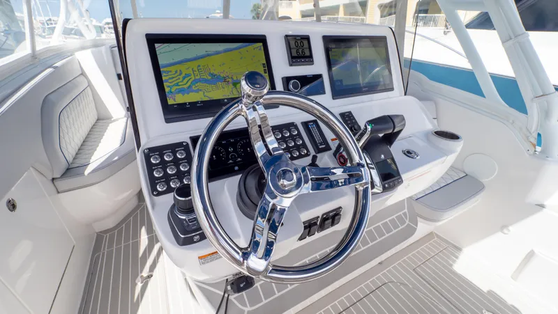 Slide: The Image of Helm of 2022 Intrepid 345 Valor boat with advanced navigation displays and controls. - 2