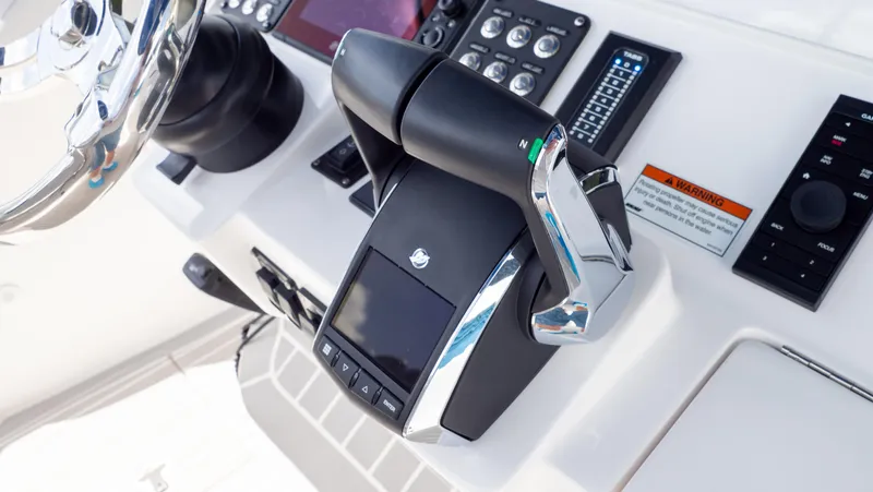 Slide: The Image of Control panel of 2022 Intrepid 345 Valor boat, featuring modern throttle and navigation controls. - 20