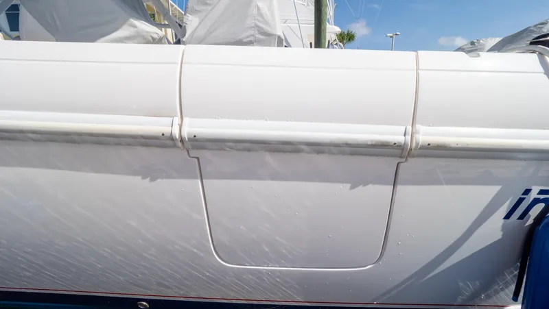 Slide: The Image of 2022 Intrepid 345 Valor boat side view with sleek white design and visible detailing. - 34