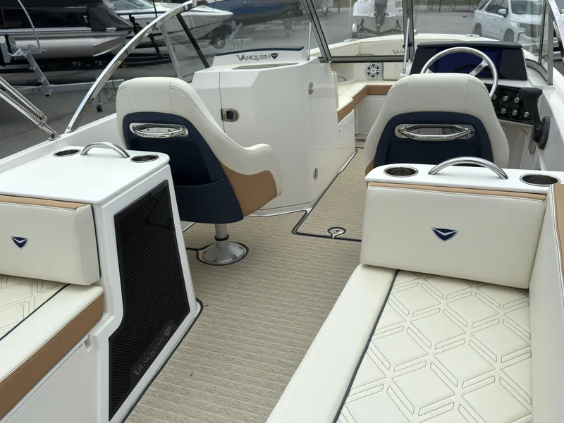 Slide: The Image of 2016 Vanquish 26 DC boat interior with white seating and modern design. - 12