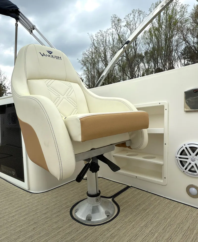 Slide: The Image of Captain's chair on 2016 Vanquish 26 DC boat, featuring beige and white upholstery. - 16