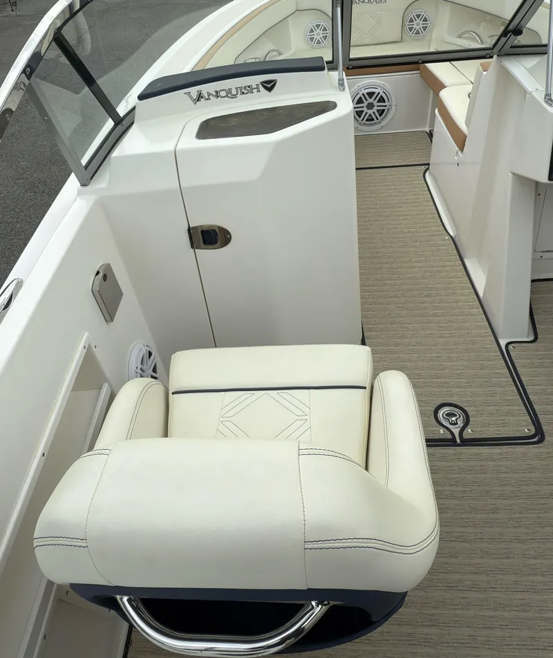 Slide: The Image of 2016 Vanquish 26 DC boat interior with white seating and modern design. - 17