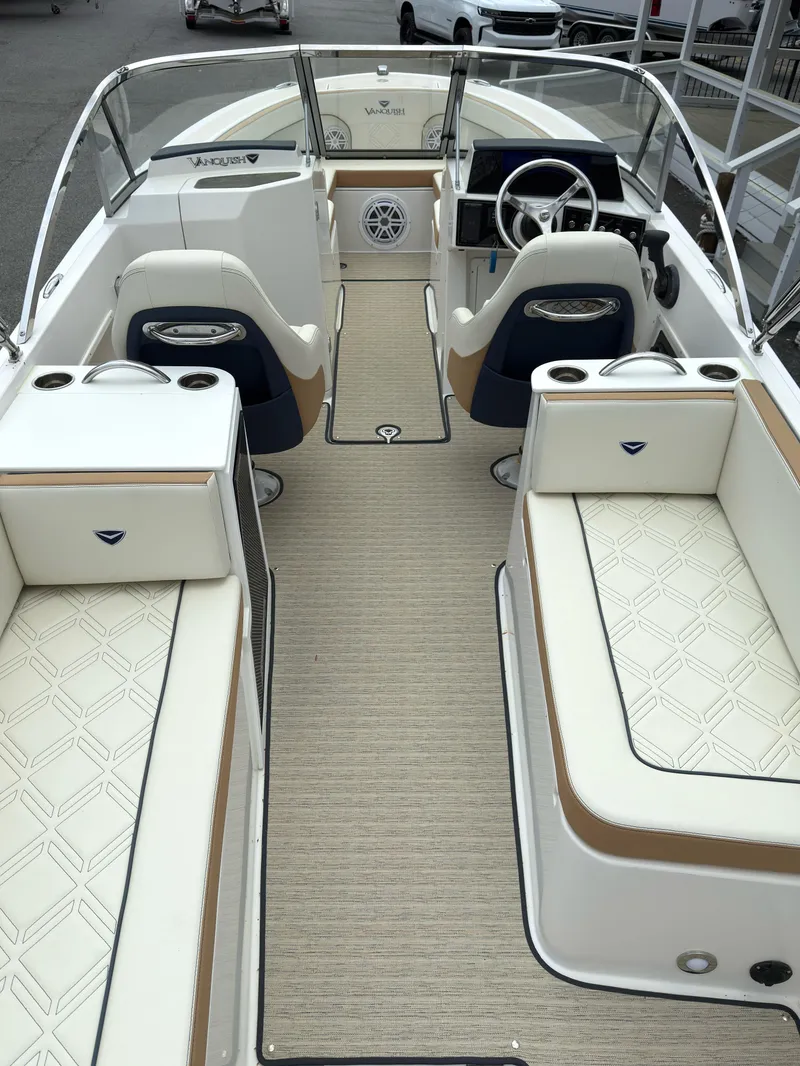 Slide: The Image of 2016 Vanquish 26 DC boat interior with elegant seating and steering wheel. - 2