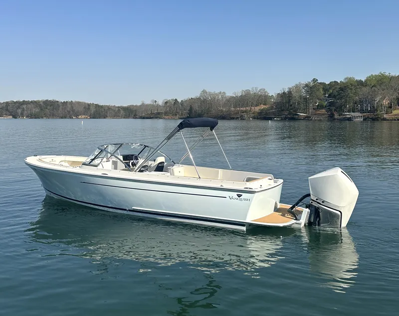 Slide: The Image of 2016 Vanquish 26 DC boat on calm lake with clear sky. - 22