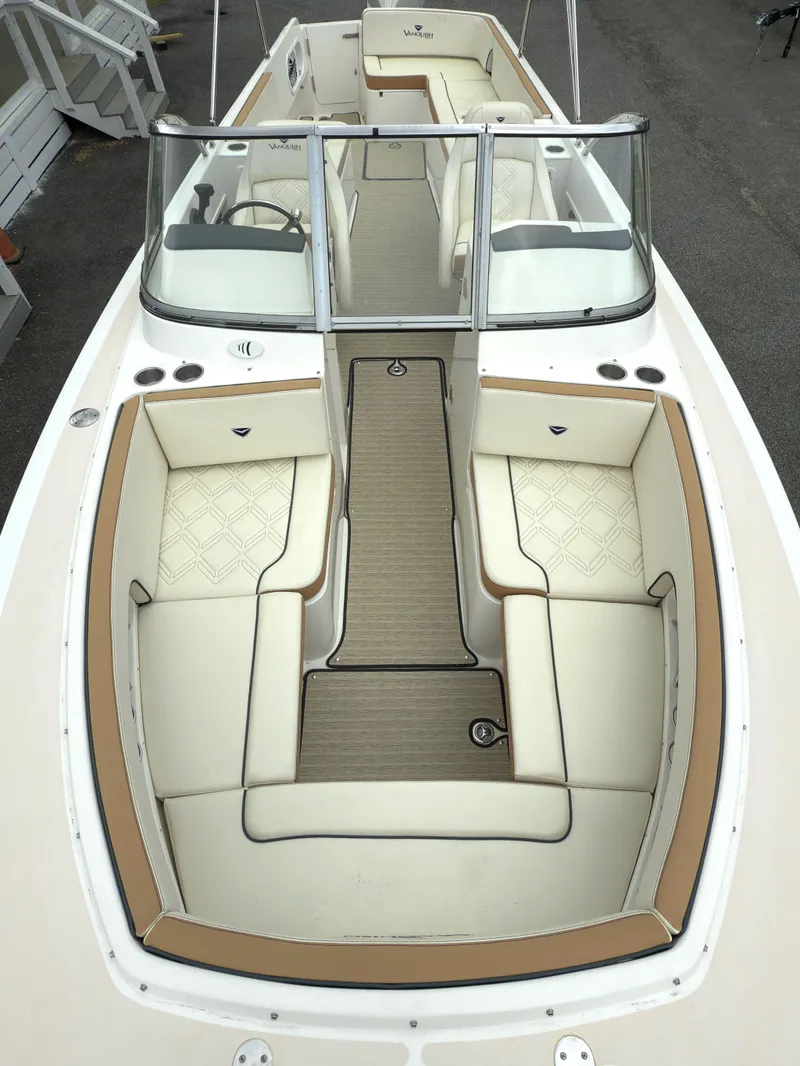 Slide: The Image of 2016 Vanquish 26 DC boat on calm water with forested background. - 3