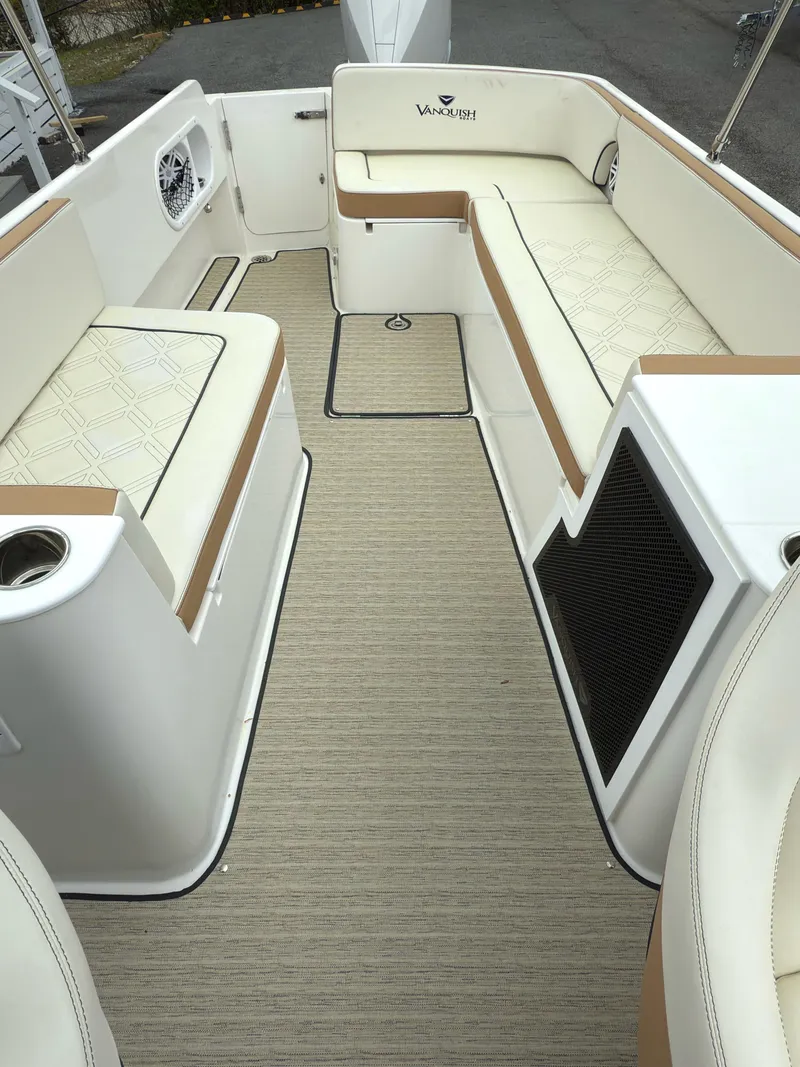 Slide: The Image of 2016 Vanquish 26 DC boat on calm lake with trees in background. - 4