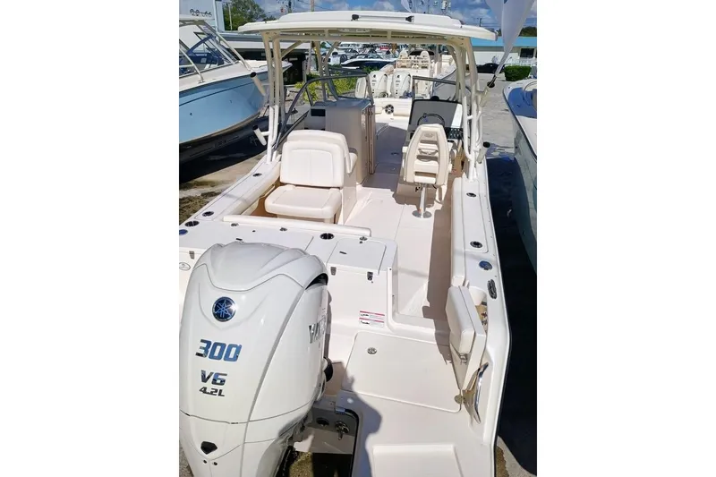 Slide: The Image of 2024 Grady-White Freedom 235 boat with 300 V6 engine, docked outdoors. - 10