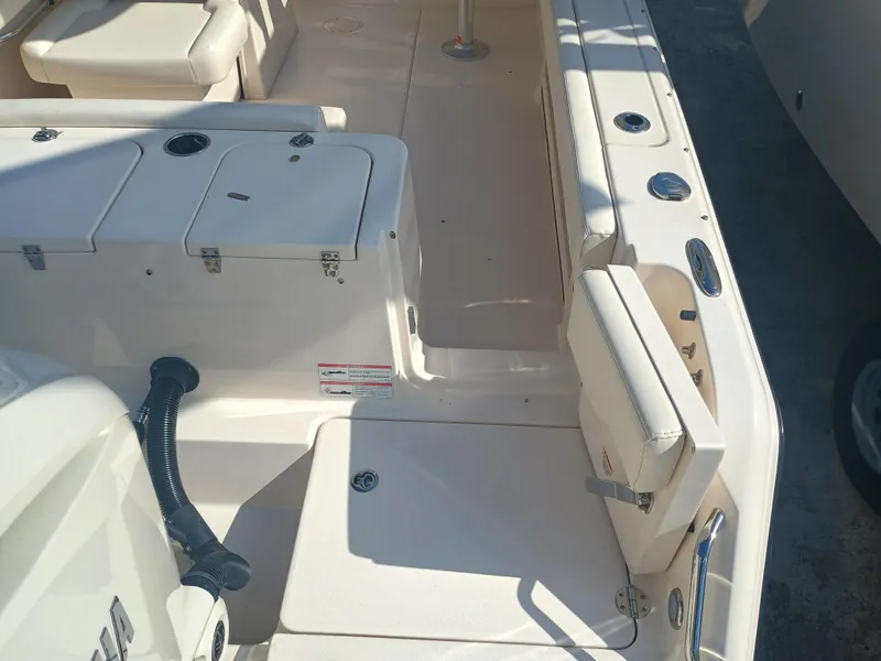 Slide: The Image of 2024 Grady-White Freedom 235 boat interior with seating and storage compartments. - 13