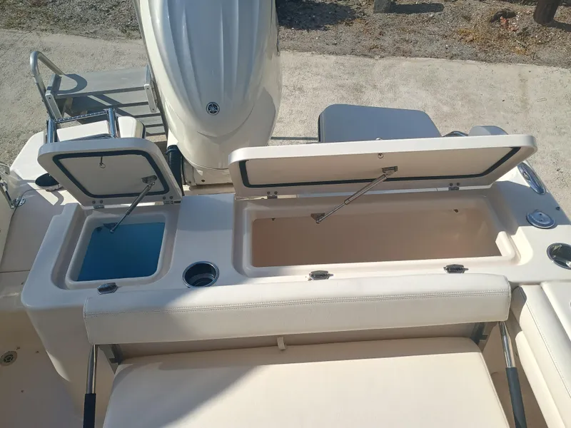 Slide: The Image of 2024 Grady-White Freedom 235 boat with open storage compartments and seating area. - 14
