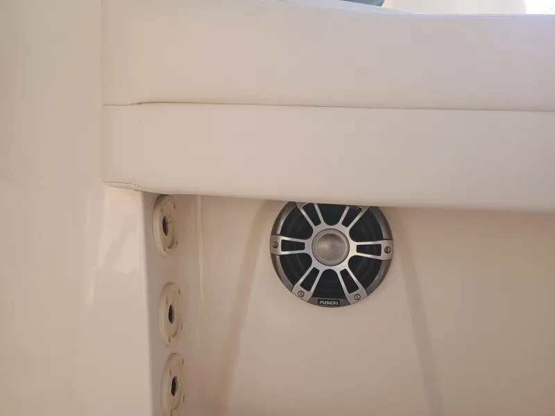 Slide: The Image of 2024 Grady-White Freedom 235 boat interior with speaker and seating detail. - 18