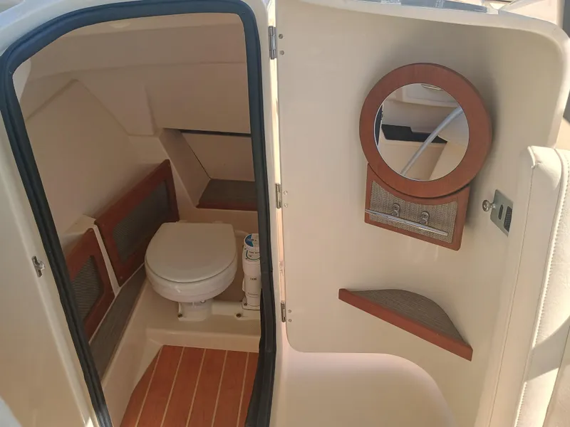 Slide: The Image of 2024 Grady-White Freedom 235 boat interior with toilet and mirror. - 25
