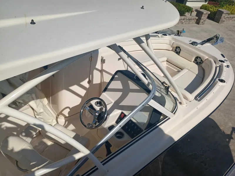 Slide: The Image of 2024 Grady-White Freedom 235 boat interior with steering wheel and seating area. - 29