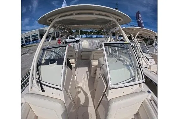 Slide: The Image of 2024 Grady-White Freedom 235 boat interior with seating and helm, displayed outdoors. - 7