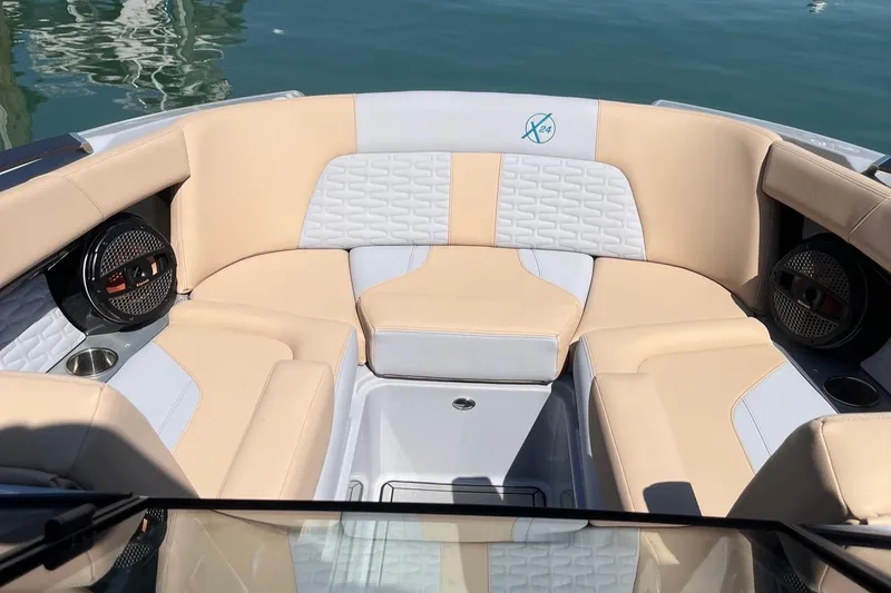 Slide: The Image of 2025 MasterCraft X24 boat interior with beige seating and modern design. - 6