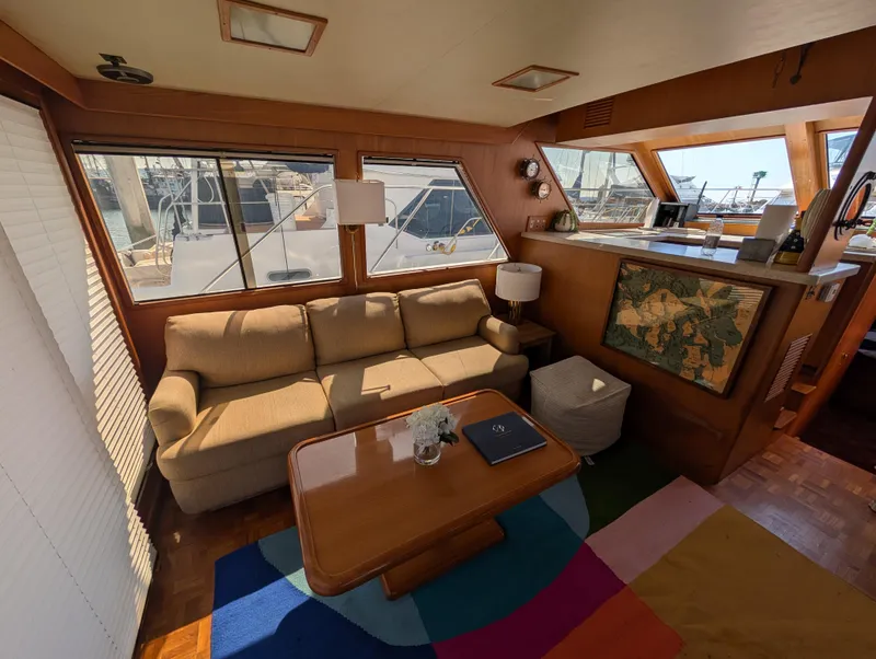Slide: The Image of Interior of 1986 Ocean Alexander 39 Sedan yacht with cozy seating and nautical decor. - 12