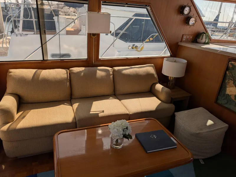 Slide: The Image of Interior of 1986 Ocean Alexander 39 Sedan with beige sofa and wooden table. - 13