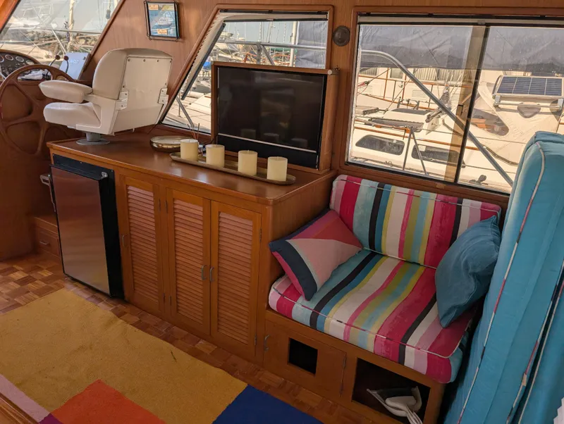 Slide: The Image of Interior of 1986 Ocean Alexander 39 Sedan with colorful seating and wooden cabinetry. - 16
