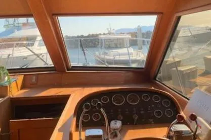 Slide: The Image of 1986 Ocean Alexander 39 Sedan helm with view of marina through large windows. - 21